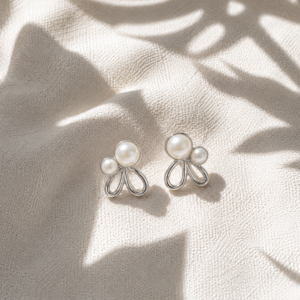 Pearl Petal Knot Stud Earrings featuring dual pearl accents and silver-tone petal-inspired design