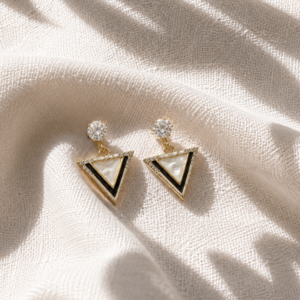Crystal triangle drop earrings with gold-tone detailing on white background