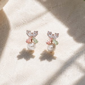 Pearl bow stud earrings for women with pastel crystal accents and rose gold finish