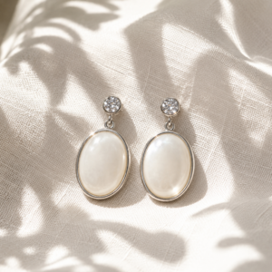 Pearl oval drop earrings with crystal stud accents and silver-tone setting