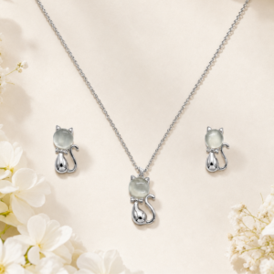 Silver cat jewelry set with matching pendant necklace and earrings featuring luminous stone accents