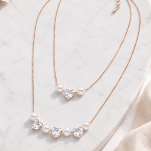 Gold double layer heart pearl chain for women with pearl accents and heart-shaped stone details