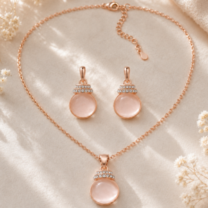 Rose Pearl Glow Jewelry Set featuring a rose gold pendant necklace and matching crystal accent earrings.
