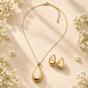 Gold pendant jewelry set with matching earrings and luminous stone-inspired accents