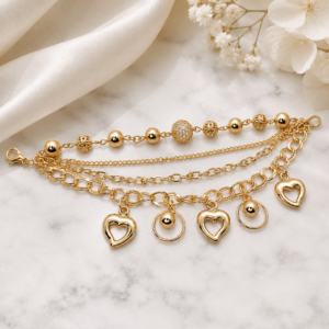 Tavielle multi-strand gold bracelet featuring open heart charms and textured beads