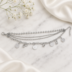 Tavielle multi-strand silver bracelet featuring a rhinestone tennis chain and dangling coin charms