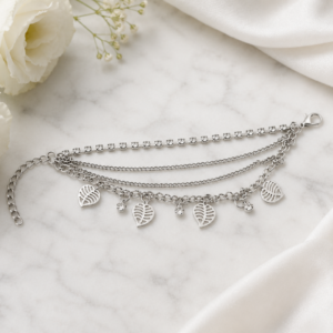 Tavielle multi-strand silver bracelet featuring a crystal tennis chain and dangling cut-out leaf charms