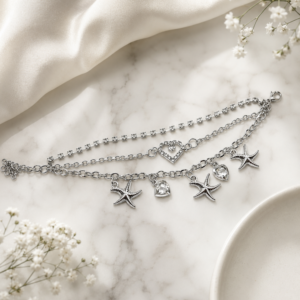 Tavielle multi-strand silver bracelet featuring a crystal tennis chain, a center heart element, and dangling starfish and crystal heart charms
