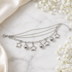 Tavielle multi-strand silver bracelet featuring dangling open star charms and faceted disco ball beads