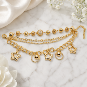 Tavielle multi-strand gold bracelet featuring star charms and textured beads