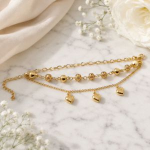 avielle multi-strand gold bracelet featuring solid heart charms and textured beads