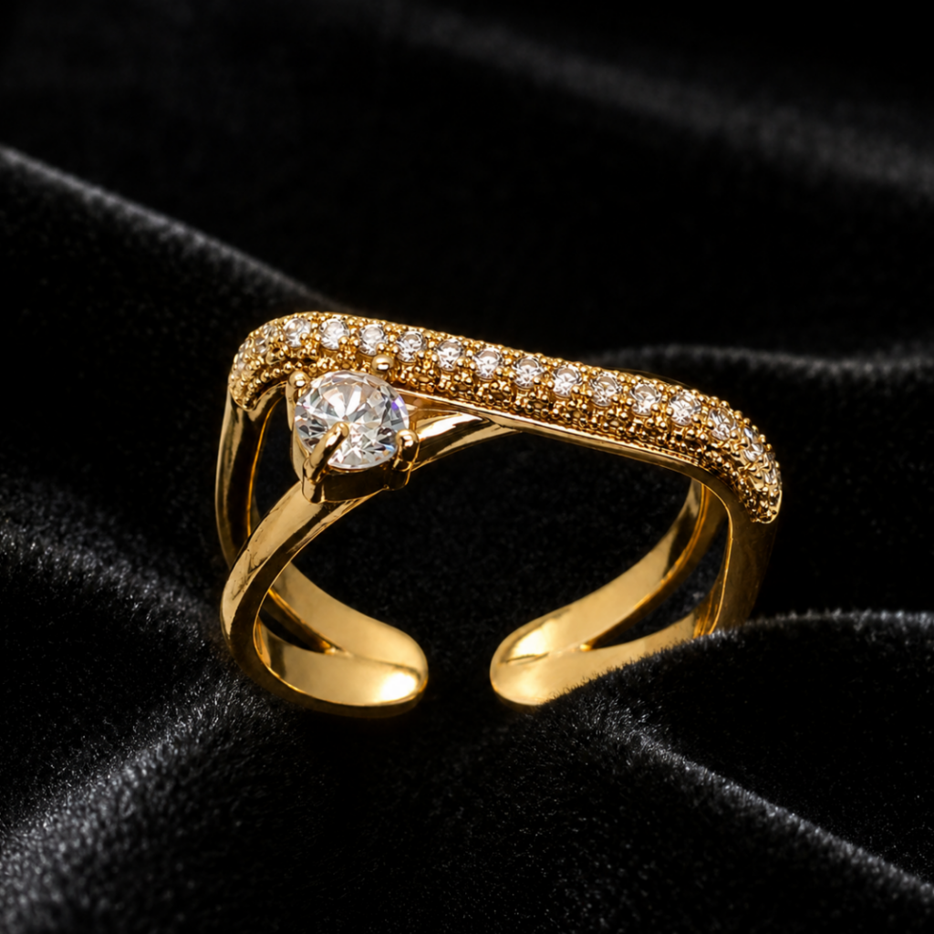 Tavielle gold ring featuring a round brilliant-cut center crystal set on an asymmetric pavé-encrusted crossover band