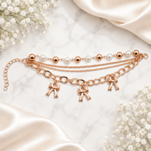 Tavielle multi-strand rose gold bracelet featuring pearl accents and bow charms
