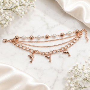 Tavielle multi-strand rose gold bracelet featuring pearl accents and dolphin charms
