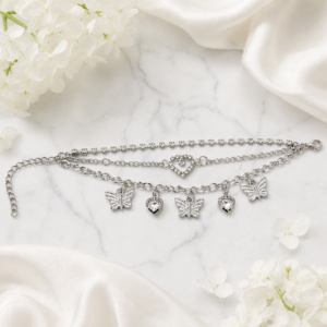 Tavielle multi-strand silver bracelet featuring a crystal tennis chain, a center heart link, and dangling butterfly and crystal heart charms