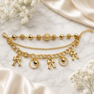 Gold layered charm necklace with beads and bow details
