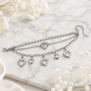 Tavielle multi-strand silver bracelet featuring a crystal tennis chain, a center heart link, and dangling open and gemstone heart charms