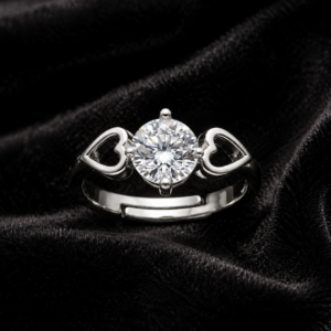 Tavielle silver ring featuring a round brilliant-cut center crystal set flanked by dual open heart motifs on an adjustable band