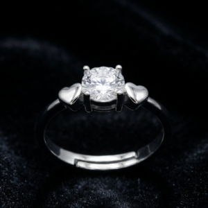 Tavielle silver ring featuring a round brilliant-cut center crystal set flanked by solid puffed heart motifs