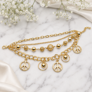 Tavielle multi-strand gold bracelet featuring peace sign charms and textured beads