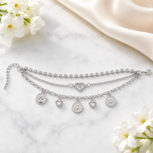 Tavielle multi-strand silver bracelet featuring a crystal tennis chain, a center heart element, and dangling coin and crystal heart charms