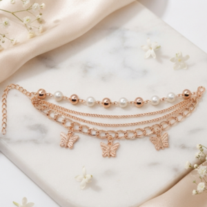 Tavielle multi-strand rose gold bracelet featuring pearl accents and butterfly charms